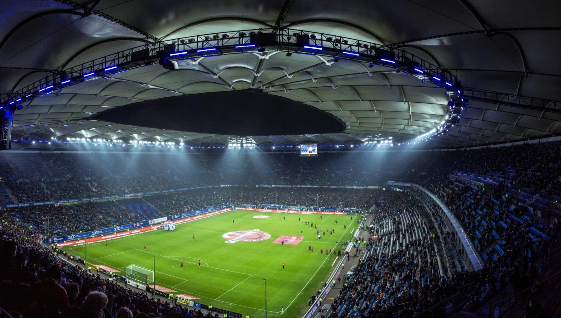 Floodlit stadium filled for an evening match